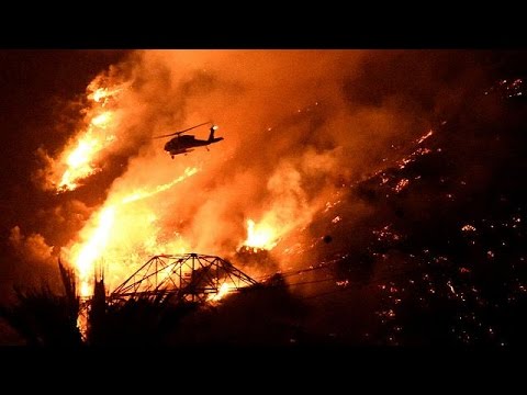 عمال الإطفاء يكافحون لاحتواء حرائق الغابات